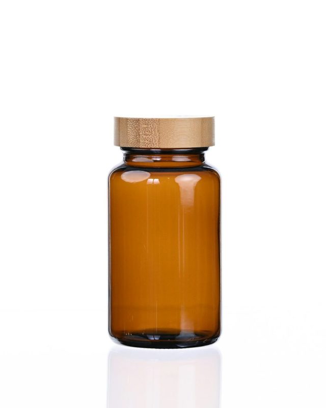 A plain amber jar with a wooden lid