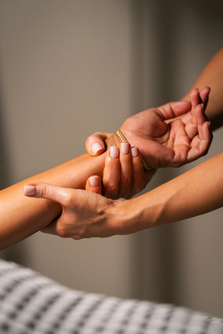 Hands working along a forearm